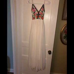 White, floor length dress with floral/tribal print
